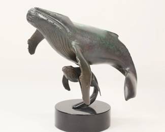 324	Dale Evers Patinated Bronze Whales	Dale Joseph Evers (American, 1955-). Patinated bronze sculpture whale with baby. Signed on the tail of the larger whale Dale Joseph Evers and numbered 9-100. On a marble base. 13 3/8"L x 12 3/8"H. Bronze loose in base.
