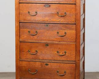106	Mission Arts and Crafts Oak Chest of Drawers	"Mission Arts and Crafts oak chest of drawers. Early 20th century. Five drawers and u-form brass pulls. Refinished with shellac coat in 1977. Information about chest on piece of paper stapled to back. Wear,  scratches, marks and ring stains to wood on top. Small chips and losses to wood on left and right edges. Cracking to wood on right front leg. Drawers have been reinforced with later plywood. Losses to wood on molding of lowest drawer.

27"" W x 16 3/4"" D x 47 3/4"" H. 74 lbs."
