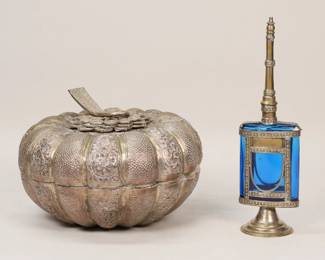 372	Melon Form Box & Rosewater Sprayer	Persian silverplate melon form box, 6 1/8"H x 8 3/4"-diameter; Moroccan rosewater bottle, cobalt glass, metal overlay, 9 5/8"H. Rosewater sprayer losses to patina on metal.
