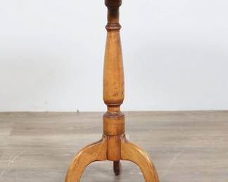 297	Federal Candle Stand	"Federal candle stand. 19th century. Turned column post and tripod base supporting circular top. Staining, marks, scratches and wear throughout wood of top. Wear and marks throughout wood of post and legs. Nail through center of top into post. Table top is very loose from post. 

18"" W x 17 3/4"" D x 26"" H. Top is 17 1/8"" diameter. 7 lbs. 

"

