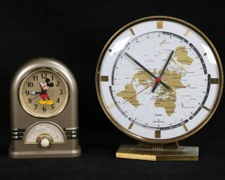 434	2 Vintage Clocks Mickey Mouse & World Clock	2 vintage clocks. Seiko for The Walt Disney Company quartz Mickey Mouse Jukebox clock, 7 1/4"H; Kieninger & Obergfell Kundo ele-quarz world clock, 10"H. Mickey Mouse clock some wear to silver tone finish on front and around face, world clock discoloration and losses to brass patina throughout. Both untested.

