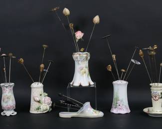 239	32 Vintage Hatpins With Holders	32 hat pins including gold tone, silver tone, cabochon, organizational, figural, floral. With 6 porcelain holders, including Royal Bayreuth tapestry, German, Austrian shoe form hatpin holder, RS Germany. Hatpin with copper 12"L, Royal Bayreuth holder 4 1/2"H.
