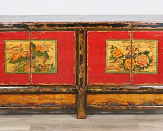 170	Distressed Chinese Sideboard	"Chinese sideboard. 20th century reproduction of  a 19th century sideboard or buffet cabinet. Faux distressing, two doors with floral motifs, two fixed shelves. Wear throughout sideboard. Chips and losses to red paint on doors. Chip and loss to wood on front right edge of sideboard. Small separation to fretwork on bottom under right side doors.

72 1/8"" W x 19 1/2"" D x 33 3/4"" H.126 lbs."
