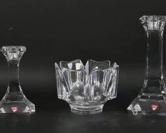 134	7 Pieces Orrefors Crystal	7 piece Orrefors Swedish art glass lot. Dish, bowl, 2 candlesticks, candle holder, pair of blue salts. Largest candlestick 7 5/8"H, bowl 3 3/4"H x 5 1/4"-diameter. All signed Orrefors, all except salts with paper labels. Larger candlestick some roughness at base, smaller candlestick fleabites at top and roughness to base.
