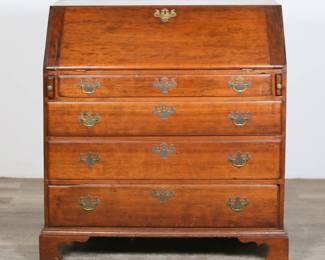 296	Federal Slant Front Desk	"Federal slant front desk. 19th century. Queen Anne style,  four drawers, lid drops down to reveal fitted interior with four drawers, eight cubbyholes, and one carved door. Wear, marks, and scratches throughout wood of exterior. Marks, staining and wear to wood on interior of desk and drawers. Losses to carved molding pieces on cubbyholes. Five separated pieces of molding are present. Brass on one drawer pull is separated but present. Repairs to lid. Splits and cracks to wood on left and right sides of desk. Chips and scratches to edges throughout bottom molding and feet. Tarnishing and wear to brass.

37 3/8"" W x 19 1/8"" D x 38 3/4"" H. 115 lbs."
