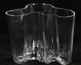 133	Alvar Aalto Savoy Art Glass Vase	Alvar Aalto (Finnish, 1898-1976). Modern art glass vase, Savoy. Signed on the underside Alvar Aalto 3030. 6 1/4"H. Chip to the rim, flakes and fleabites to the rim, scratches to underside, scratches to one side.
