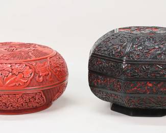 186	2 Chinese Cinnabar & Lacquer Boxes	2 Chinese carved cinnabar boxes. One with black lacquer, octagonal form, with flowers and scholars, 7 3/8"H x 11"W; cinnabar box, with flowers and temple scene, 5 1/2"H x 10 3/4"-diameter. Black lacquer box chips and losses to lacquer on interior rim, chip to roof on lid of cinnabar box.
