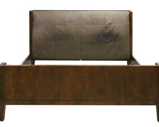 163	Barbara Barry for Baker Art Deco Style Bed	"Barbara Barry (American, 20th century). King-size Art Deco style bed designed for Baker Furniture. Mahogany, brown leather fittings on headboard and footboard, brass capped feet. Baker Furniture label on back of leather on headboard. Scratches, gouges, and marks to mahogany on headboard and footboard. Large loss to veneer on right side rail. Heavy scratches and scuffs to leather on headboard and footboard. Staining to leather on headboard. Chips and nicks to wood on edges of footboard and headboard. Wear and scuffs to wood on legs. 

82 1/8"" W x 98 3/4"" D x 50 1/2"" H. 450 lbs total."
