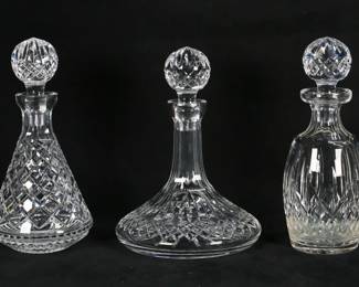427	3 Waterford Crystal Decanters	3 Waterford crystal decanters. Lismore pattern ship's decanter, Lismore pattern spirit decanter, Alana pattern decanter. Ship's decanter 10"H including stopper. All with etched Waterford marks. Alana decanter minor chip to interior end of stopper.
