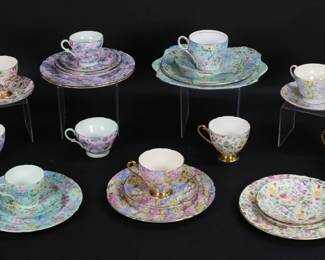 316	Shelley Chintz Porcelain Cups, Saucers, Luncheon	27 pieces Shelley English bone china, with all-over flower patterns. Rock Garden pattern luncheon plate, cup and saucer; 2 Summer Glory luncheon plates, saucers, one cup green rim and one cup gold rim, with additional demitasse cup and saucer; Countryside luncheon plate, 2 cups and 2 saucers; Melody square tray, 2 luncheon plates, cup, saucer, demitasse cup and saucer; Maytime cup and saucer; Primrose cup and saucer. Square tray 9 3/4"W.
