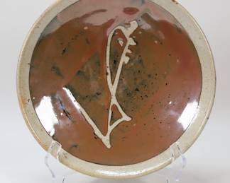 321	Attributed to Shoji Hamada Pottery Charger	Attributed to Shoji Hamada (Japan, 1894-1978). Japanese stoneware pottery plate. Unsigned, no box. 10 3/4"-diameter. Glaze pops throughout.
