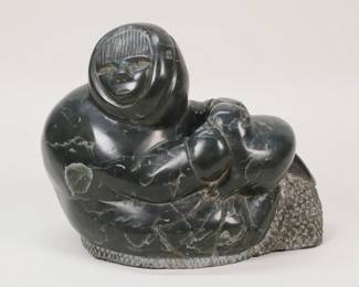 370	Inuit Stone Carving Figure With Seal	Inuit stone carved sculpture, figure with seal. Signed on the underside. 8"H x 9 3/8"L.
