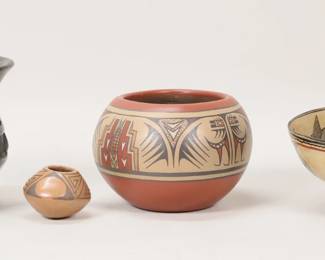 191	4 Pieces Pottery Native American & South American	4 pieces Native American and South American pottery. Margaret Luther Santa Clara Pueblo vase, 3 5/8"H; Rose Montoya blackware Santa Clara Pueblo vase, 4 7/8"H; small vase signed SWP, 1 5/8"H; Sarayaku bowl, unsigned, 3"H x 6 5/8"-diameter. Chips to rim of Sarayaku bowl.
