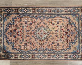 396	Persian Style Rug	"Persian style rug. Floral motifs and medallion against blue and pink field. Losses, staining, and tattering to fringed edges. Light fading, stains and wear throughout rug. 

2' 10 1/8"" x 4' 10 1/2"". 6 lbs."

