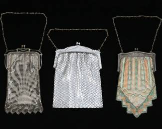 232	5 Whiting & Davis Mesh Bags	"5 signed Whiting & Davis mesh purses. Silver tone bag with silver tone frame, 4 3/4""W x 6 3/4""L; silver tone and black enamel frame and art deco motif in black, 4""W x 7""L; silver tone frame with green, yellow, brown and black floral decoration, 3 7/8""W x 6 1/2""L; silver tone frame with pink, green and blue art deco floral motif, 4 3/8""W x 7 3/4""L; silver tone frame with geometric art deco motif in green, brown and orange, 3 3/4""W x 7""L. 

Silver tone bag scratches and losses to frame, loss to color on bag with enamel frame, bag with pink flowers tears to lining and minor losses to color on bag, green and orange bag minor losses to color."

