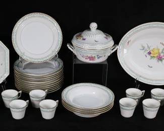 310	30 Pieces KPM Kurland Form Porcelain Dinnerware	30 pieces KPM porcelain dinnerware, Kurland form, with gilt and green enamel rims with white swags, serving pieces with hand painted decoration of flowers and butterflies.12 dinner plates, 4 bowls, 11 cups, oval platter, lidded tureen, serving bowl. All with blue scepter marks, platter, tureen and serving bowl with red orb marks, plates and bowls with green orb marks. Dinner plates each 10 1/4"-diameter, platter 16 1/8"L.
