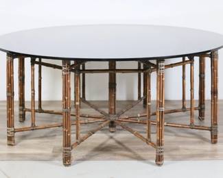 165	Mid Century Modern McGuire Bamboo Table	"Mid Century Modern Hollywood Regency style dining table by the McGuire company (San Francisco, founded 1948). 20th century. Bamboo base, rawhide bindings, circular smoked glass top. Fraying and separations to bindings throughout tops of legs. Scratches, scuffs and wear to bamboo. Large gouge to wood on one bamboo leg. Losses to bindings on bottom of one leg. Scratches, gouges, scuffs and marks throughout glass. Small fleabites to edges of glass. Large chip to one edge of glass. 

29 3/8"" H x 71 3/4"" diameter. 445 lbs total."
