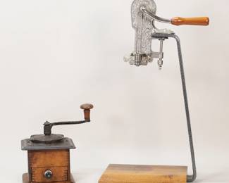 79	Champion Wine Opener & Vintage Coffee Grinder	Vintage wood and iron coffee grinder, 6 1/2"W x 6 1/4"D x 9 3/8"H; Champion corkscrew wine opener on stand, corkscrew 8 3/4"H, with stand 23 1/2"H. Discoloration and staining to base of corkscrew stand, chips and losses to wood on coffee grinder, chip at drawer.
