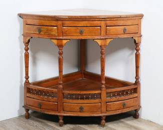 294	William and Mary Style Corner Table	"William and Mary style corner table. 20th century. Six drawers with brass pulls and lower tier. Large split and crack to wood across top. Scratches and marks to wood of top. Wear and scratches to wood of lower tier. Nicks and scuffs to feet. Losses to wood on back foot. 

39"" W x 28"" D x 33 3/8"" H. 36 lbs."
