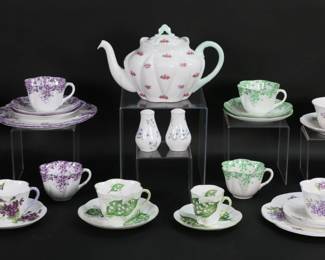313	Shelley Porcelain Cups & Saucers, Teapot	30 pieces Shelley English bone china. 3 luncheon place settings, each with luncheon plate, cup and saucer: 2 Dainty Mauve pattern, 1 Lilac; 6 cups and saucers: Pansy, Stocks, Violets, Lily of the Valley, 2 Dainty Green; and 3 demitasse cups and saucers: Violets, Lily of the Valley, Thistle. With a Rosebud pattern teapot and a pair Blue Rock of salt & peppers. Teapot 6"H x 10"L, luncheon plates 8 3/8"-diameter.
