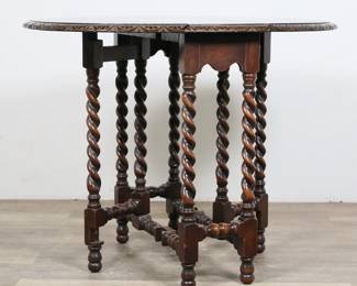 215	William and Mary Style Gate-Leg Tavern Table	"William and Mary style gate-leg tavern table. Early 20th century. Barleytwist legs and stretcher, gate legs supporting drop-leaves. ""B & S Co."" manufacturer's label on underside of top. Wear, staining, marks, scuffs and scratches throughout top and leaves of table. Small chips to edges on one table leg. Wear throughout legs and stretcher. 

27 3/8"" W x 10 1/2"" D x 28 1/4"" H. With leaves extended: 35 3/4"" W x 28 1/4"" D x 28 1/4"" H. 28 lbs."
