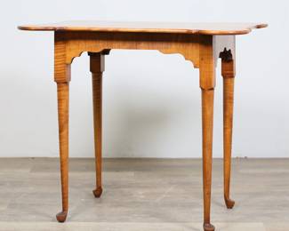56	Queen Anne Style Tiger Maple Occasional Table	"Queen Anne style tiger maple occasional or side table. Late 20th century. Tiger maple, porringer corner top, straight tapering legs with pad feet. Small black scuffs and scratches to top of table. Loss and chip to wood on capital of one leg. Nicks and scratches to wood on one leg of table. Small white blemishes to wood on one section of apron. 

31 7/8"" W x 22 5/8"" D x 26 3/4"" H. 17 lbs."
