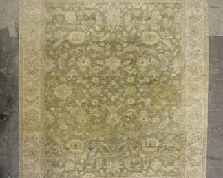 338	Persian Rug	"Persian rug. Sage and cream colored with foliate motifs and fringed edges. Large stain near center of rug. Wear throughout rug. 


10'2"" x 8' 2"""
