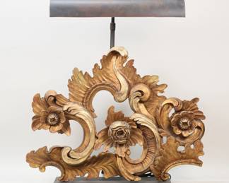 418	Restoration Hardware Acanthus Scroll Task Lamp	Restoration Hardware acanthus scroll task / table lamp. Carved giltwood on an iron base, with adjustable iron shade. 26"W x 26 1/4"H at lowest height. Screw to hold adjustable shade in place missing, losses and scratches to patina on iron throughout, horizontal crack to the carving visible on the reverse, minor losses to gilt painting.
