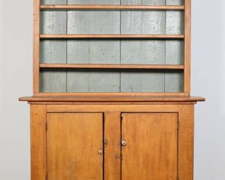 104	American Primitive Step-Back Cupboard	"American primitive step-back cupboard. 19th century. Maple, blue-painted interior, five total fixed shelves and two doors. Scratches, scuffs, marks and wear throughout wood. Lowest shelf in cabinet is slightly loose. Chips to wood on bottom edges of feet. Head of nail on left side of top of lower cabinet is protruding out 1/4"". Chips and losses to wood on top left corner of right door. Small chips and losses to wood along edges of top and back left and right edges.

57 3/4"" W x 19 5/8"" D x 73 1/8"" H. 200 lbs."
