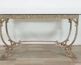 216	Rococo Style Metal and Glass Dining Table	"Rococo style metal and glass dining table. 20th century. Large beveled rectangular glass top and metal base with scroll and curve forms. Wear and losses to finish on base. Scratches and scuffs throughout glass. Small chips and fleabites to edges of glass on two corners.

84"" W x 48"" D x 30 1/4"" H. 230 lbs total."
