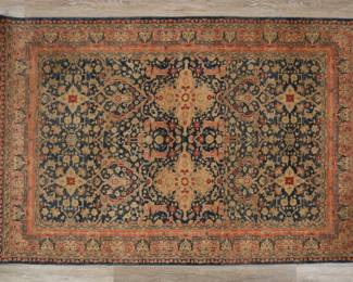 343	Persian Style Rug	"Persian style rug. Floral motifs against red and blue field with fringed edges. Fading and wear throughout rug. Wear to fringe. Small staining near center of rug. 

4' 3/4"" x 6' 1/2"". 19 lbs."
