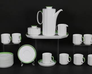 432	28 Piece Tapio Wirkkala for Rosenthal Coffee Set	Tapio Wirkkala (Finland, 1915-1985) for Rosenthal. 28 pieces Rosenthal Studio Line modern porcelain, in the Sunion pattern. Coffee / chocolate set for 12, white with green rims. Including: 12 cups, 12 saucers, coffee pot, lidded sugar, creamer, tray. All signed Rosenthal Studio-Linie Germany on the underside, saucers additionally signed Tapio Wirkkala Rosenthal in the center. Tray 12 3/4"L, coffee pot 8 3/4"H, cups each 2 5/8"H. Losses to green on rim of one saucer.
