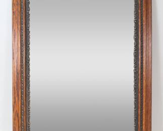 53	Victorian Style Mirror	"Victorian style mirror. 20th century. Carved oak frame with filigree motifs. Chips and losses to wood on edges and corners of frame. Losses to carving on inner sections of frame. Wear and light scuffs to mirrored surface. 

32"" x 26"". 16 lbs."
