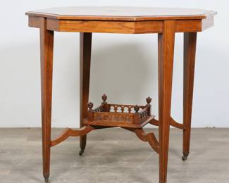 300	Edwardian Inlaid Octagonal Center Table	"Edwardian inlaid octagonal center table. Early 20th century. Satinwood parquetry inlay, tapered legs on casters, lower tier with gallery and urn finials. Chips and losses to veneer on edges of top. Scuffs and scratches to wood on lower tier. Wear throughout wood of table. 
29 1/4"" W x 29"" D x 27 1/8"" H. 18 lbs."
