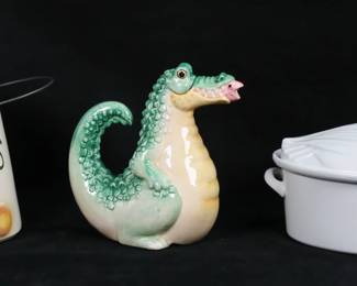 425	3 Pieces Decorative Pottery Fitz & Floyd, Carbone	3 piece decorative ceramic lot. Fitz & Floyd dragon pitcher, signed FF 1987, 8 7/8"H; Carbone duck covered casserole serving dish, 12 1/2"L; McCoy coffee pot cookie jar, 9 1/2"H. Dragon flakes and chips to lid, chip to one tooth; cookie jar crazing throughout, paint loss to lettering and mug.
