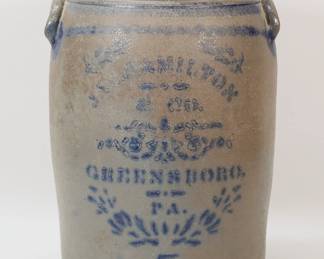 73	5 Gallon James Hamilton Greensboro Stoneware Crock	5 gallon blue decorated 2 handled stoneware crock. Jas. Hamilton & Co., Greensboro, PA. 15 3/8"H x 9"-diameter at top. Losses to painted lettering, minor chips to handles, minor chip to base, scratch and lines to interior of rim.
