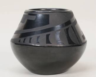 190	Maria & Julian Blackware Pottery Vase	Maria Martinez (San Ildefonso Pueblo, 1887-1980) and Julian Martinez (San Ildefonso Pueblo, 1879-1943). San Ildefonso blackware pottery vase. Signed on the underside Marie & Julian. 3 7/8"H. Light scratches.
