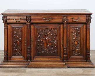 210	French Renaissance Revival Carved Sideboard	"French Renaissance Revival carved sideboard or buffet. Late 19th century. Walnut, carved devil grotesques, brass hardware. Original top of sideboard is no longer present. One key is included. Wear, marks and scratches to wood throughout top. Slight separations to back paneling. Holes from original top. Drawers lined with paper. Wear and scratches to interior and shelf. Lock plate is missing from central door. Chip and loss to molding on bottom right front corner. Chip to wood on left front corner of top. Key is slightly bent.

63 3/4"" W x 23"" D x 36 1/4"" H. 80 lbs."
