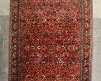 334	Persian Rug	"Persian rug.. Red and blue rug with foliate motifs throughout. Small fringe loss to edges. Stain to rug  to rug near center. 


9'3"" x 6'8""."
