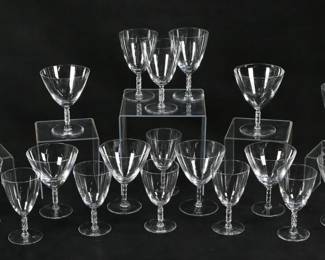 153	21 Pieces Lalique Guebwiller Stemware	21 pieces signed Lalique crystal stemware in the Guebwiller pattern. 8 Champagnes / sherbets, each 5"H; 5 Burgundy wines, each 5 3/8"H; 8 wines, each 5"H. 4 sherbets, 2 Burgundy wines and 2 wines all signed Lalique France; 4 sherbets, 3 Burgundy wines and 6 wines all with etched R. Lalique marks to the undersides. Chips to rim of one champagne.
