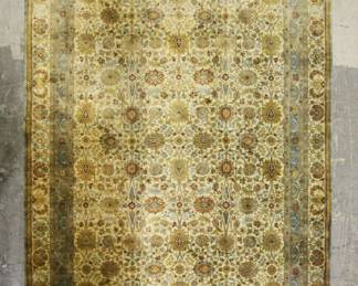 335	Handmade Woolen Indian Rug	"Handmade woolen rug. Made in India. Tag on back of rug. Blue and green with floral motifs throughout. Small losses to fringe on one side of rug. Wear throughout rug. 

11' 9"" x 9'"
