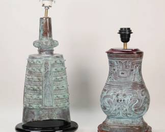 177	2 Chinese Bronze Archaic Style Lamps	2 archaic style Chinese bronze table lamps. Green patina, both mounted on wooden bases. 16 1/4"H and 20"H (heights to top of sockets). Both with chips and losses to wooden bases and fittings.
