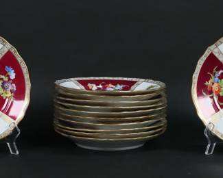 312	Set of 12 RK Dresden Porcelain Luncheon Plates	Set of 12 Richard Klemm Dresden German porcelain quatrefoil luncheon plates. Hand painted with alternating panels of courting scenes and flowers. All marked with blue RK Dresden Germany crown marks. Each 8 3/8"-diameter. Paint loss to gilt decoration on rims and throughout, some paint loss to red portions, chip to the underside of one.
