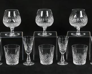 152	18 Pieces Waterford Crystal Stemware	18 pieces signed Waterford stemware in various patterns. All with etched Waterford marks. 3 Kenmare pattern old fashioned glasses, each 3 1/2"H; 2 Kenmare white wines, each 5 1/2"H; 4 Kylemore sherry glasses, each 5 3/8"H; 3 Colleen brandy glasses, each 5 1/8"H; 6 Boyne cordials, each 3 1/4"H. Rim chip to one old fashioned, white wines one with roughness to rim.
