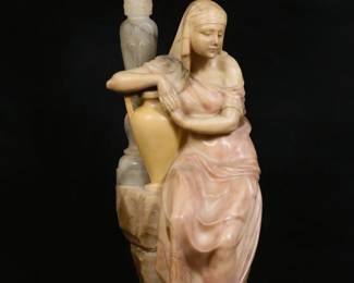 306	G. Mascagni Signed Italian Art Deco Alabaster Lamp	"G. Mascagni (Italian, 20th century). Figural Art Deco Egyptian Revival alabaster lamp. Woman with urn sitting against rock supporting lamp. Lid of lamp marked ""Italy //31"". ""G. Mascagni"" signed into alabaster on back of figure. Wear throughout alabaster. Small chips and losses to nose of figure.  Small chips and roughness to edges of lid. Small chips on edges of base. Scuffs to sides of lamp. Lighting has been tested and does not work. 

14"" 3/8"" W x 15 3/4"" D x 32"" H. 77 lbs."
