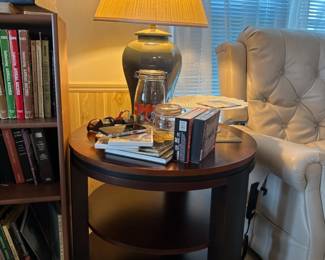 two end tables round in shape and tri level, lamps