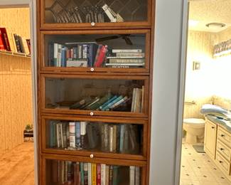 Gorgeous mid century modern book case. About 7ft tall. Doors open upward and slide back.
