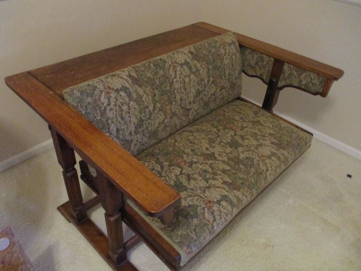 This is an absolutely unique antique piece. The couch shown in the photo converts into a beautiful table.
