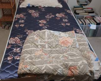 twin   trundle  bed,  spread,  lots  of  picture  frames  