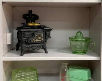 Cookbooks, Antique Salesman Sample Cast Iron Crescent Wood Burning Stove, Green Depression Glass measuring cup with juicer, McKee Jadeite Butter Dish, Green Depression Glass Butter Dish